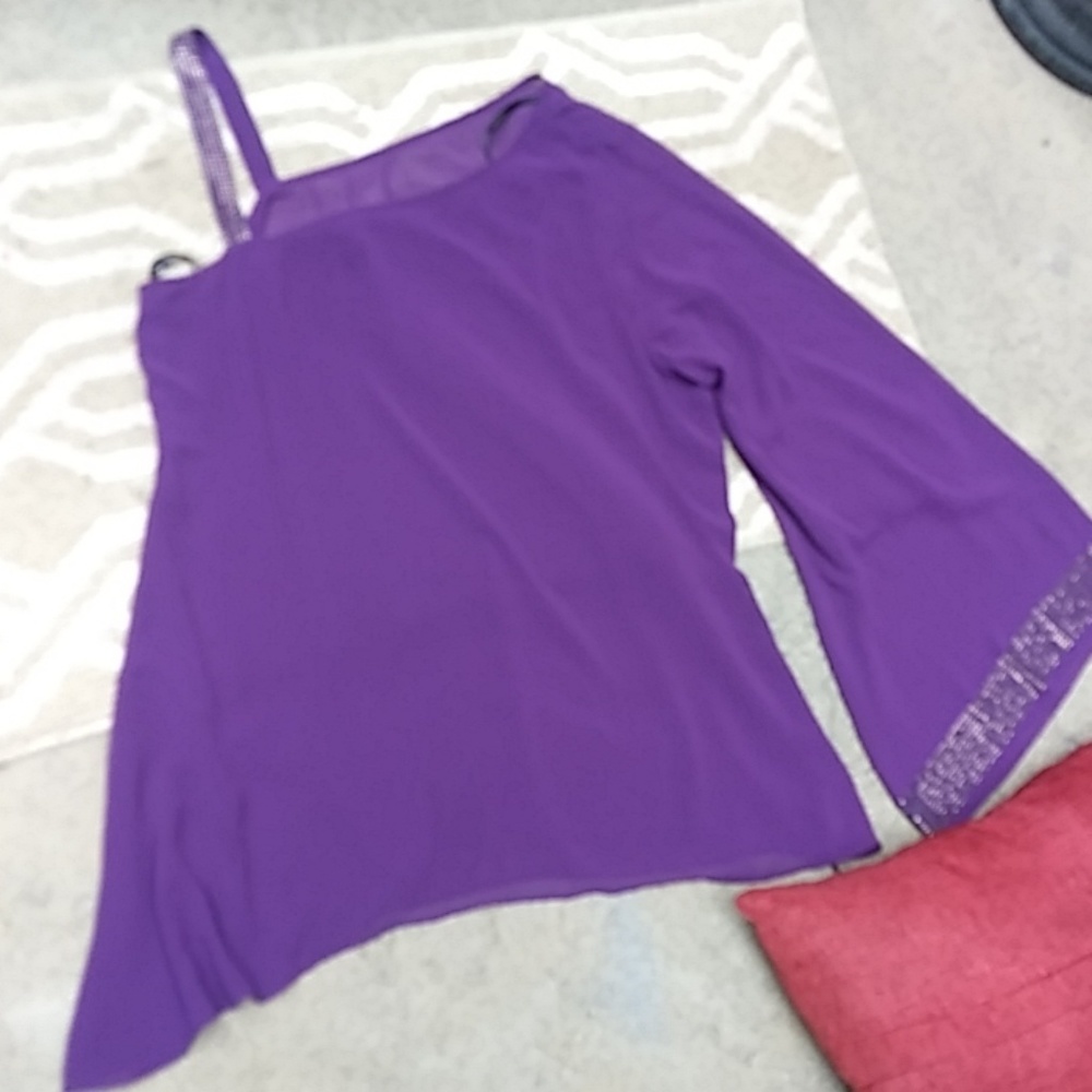 Elegant off one shoulder blouse by Bebe.